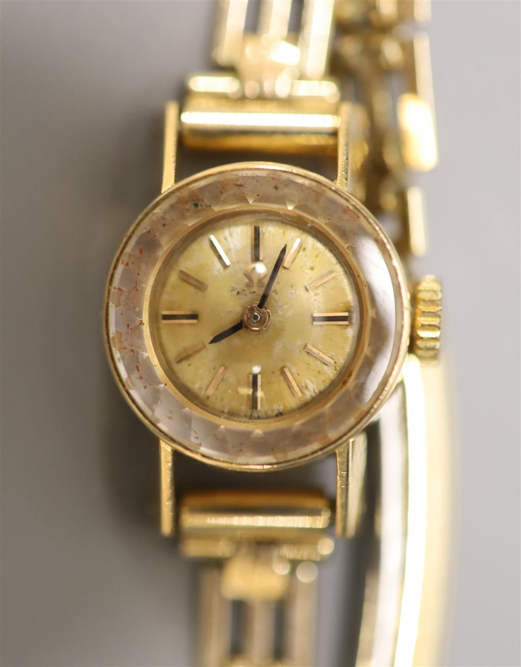 A ladys 1960s 18ct gold Omega manual wind wrist watch, on a gold plated bracelet with box and guarantee,